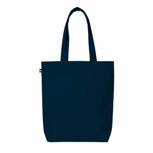 Sac cabas en coton beige avec soufflet de fond, fabriqué en France, posé sur une table en bois avec accessoires de mode

