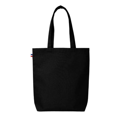 Sac cabas en coton beige avec soufflet de fond, fabriqué en France, posé sur une table en bois avec accessoires de mode

