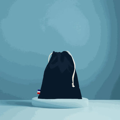 pochon en coton tissé noir avec cordon blanc, fabriqué en France, durable et élégant, sur fond bleu